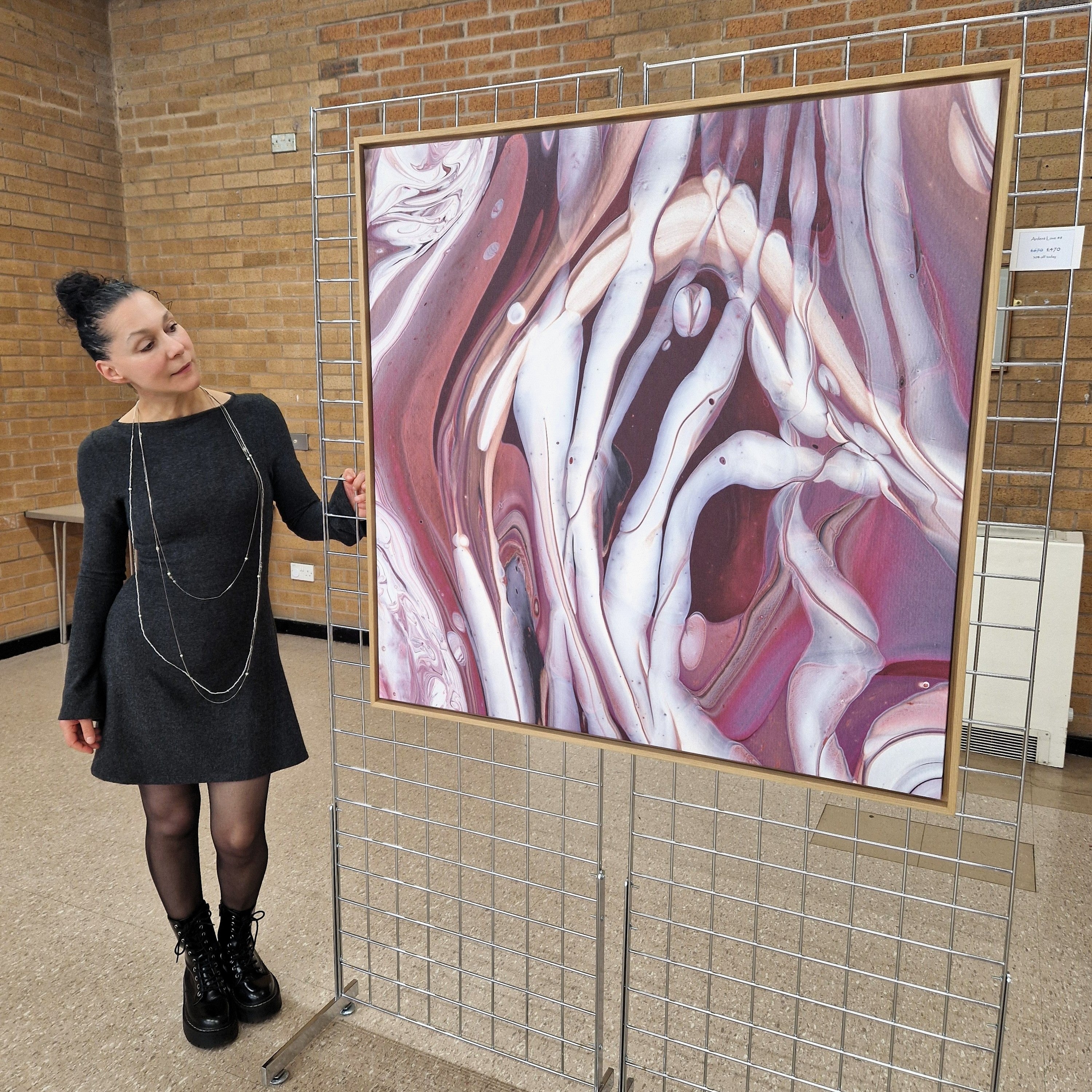 Artist standing next to large framed canvas print-oak frame