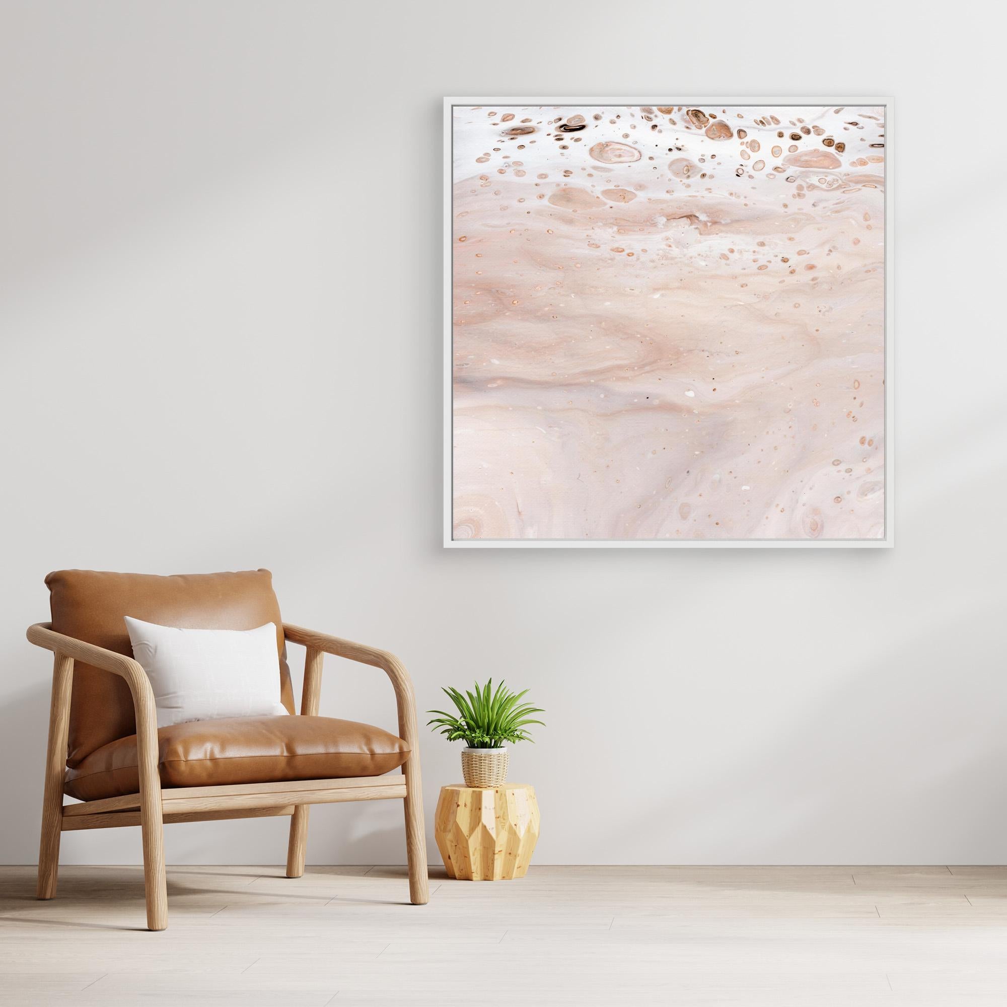 NL modern art Art Prints Soothing Neutrals 1 in white frame on wall next to comfy chair and small plant