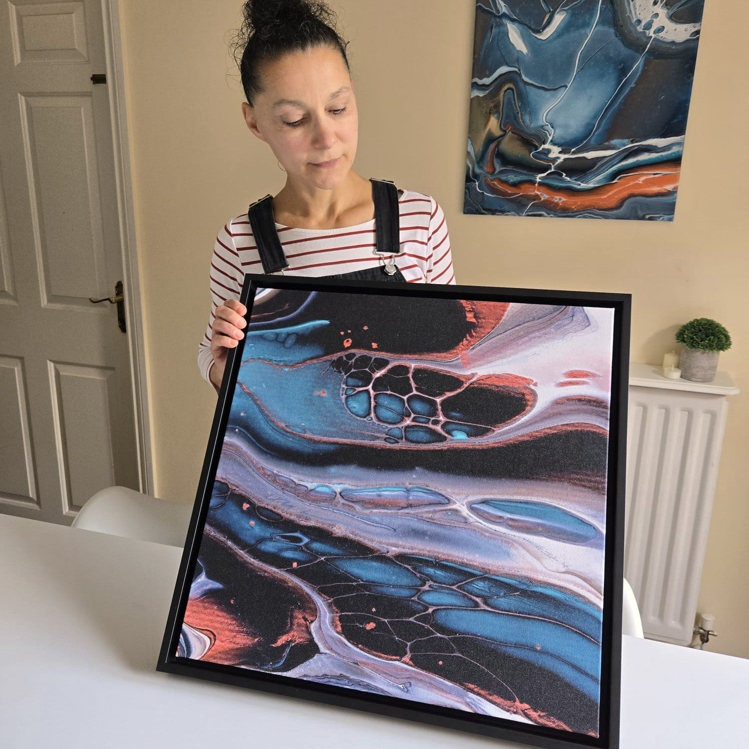 Nadya Lamara Artist holding Healing Teal 6 Canvas Print in black frame
