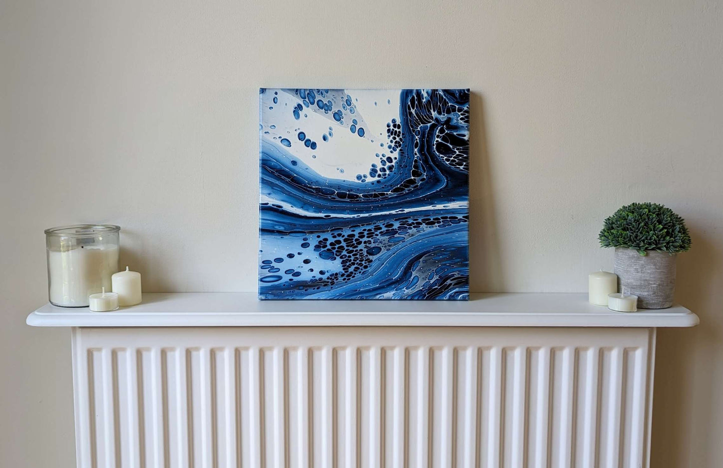 Canvas on shelf – frontal view of original abstract painting. Made with professional grade acrylic paint: Prussian blue and white.