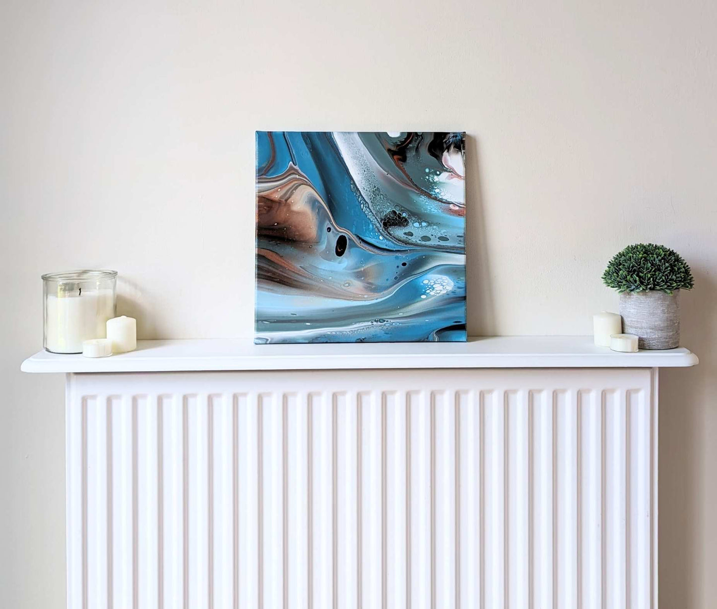 Canvas on shelf – frontal view of original abstract painting in muted hues made with professional grade acrylic paint.