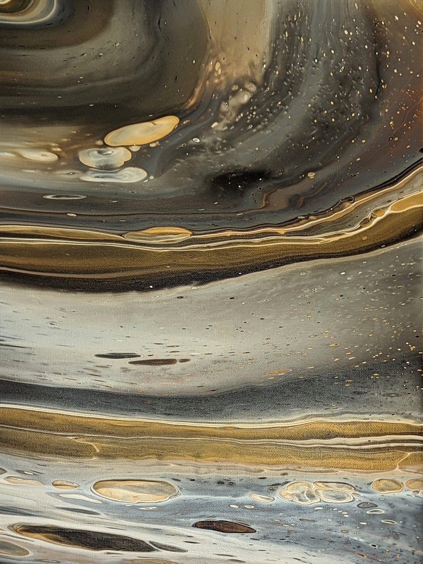 Close-up of original abstract painting in grey hues with gold made with professional grade acrylic paint.
