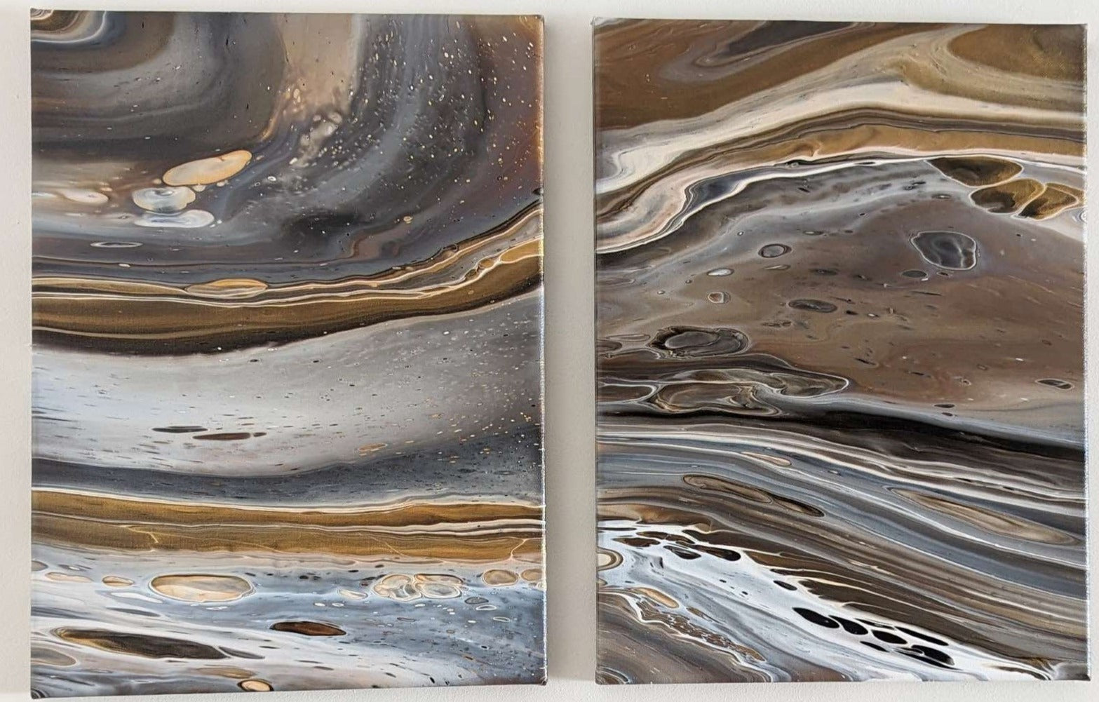 Close-up of original abstract diptych in grey hues with gold made with professional grade acrylic paint.