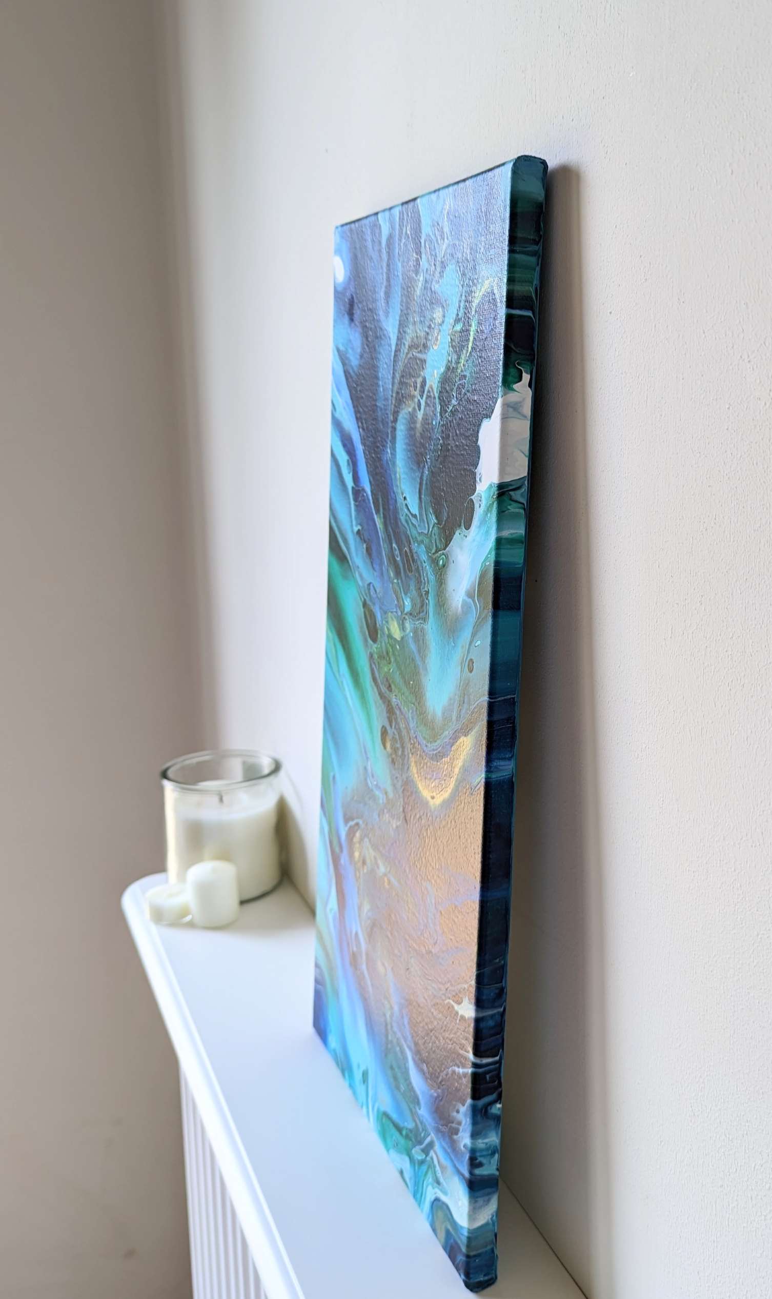 Canvas on shelf – side view of original abstract painting made with high contrast and gold professional grade acrylic paint.