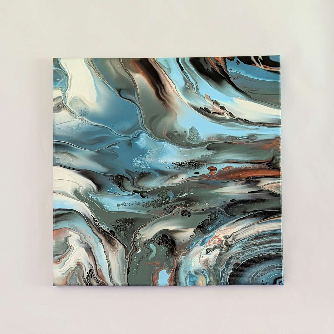 Canvas on wall – frontal view of original abstract painting in muted hues made with professional grade acrylic paint.