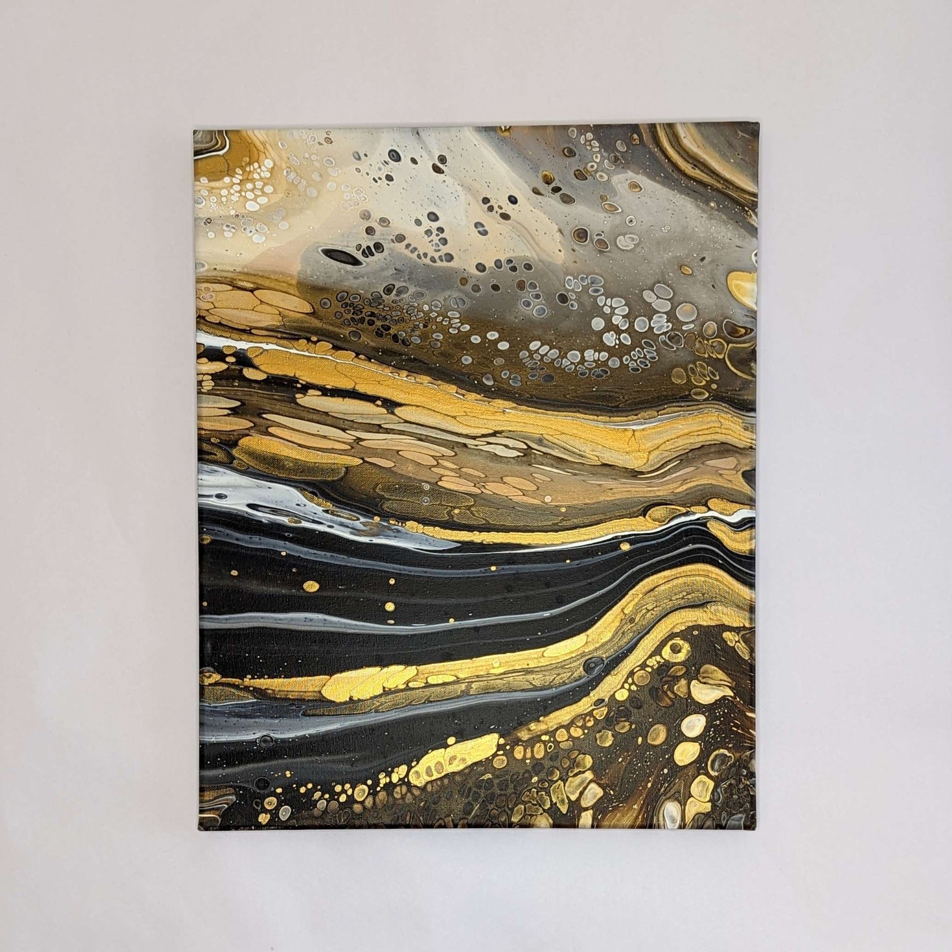 Canvas on wall – frontal view of original abstract painting with high contrast and gold. Made with professional grade acrylic paint.