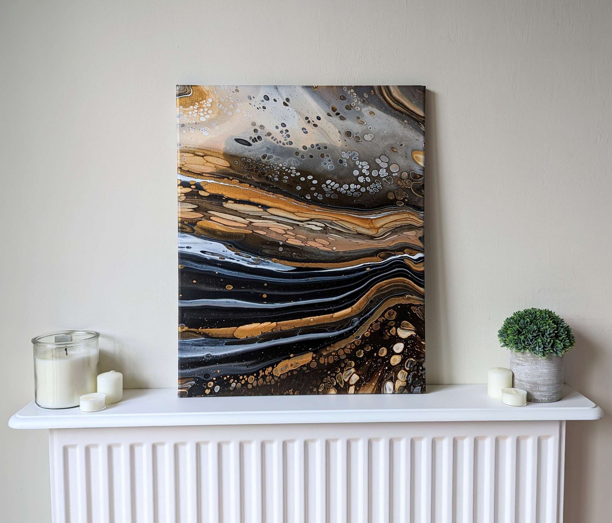 Canvas on shelf – frontal view of original abstract painting with high contrast and gold. Made with professional grade acrylic paint.