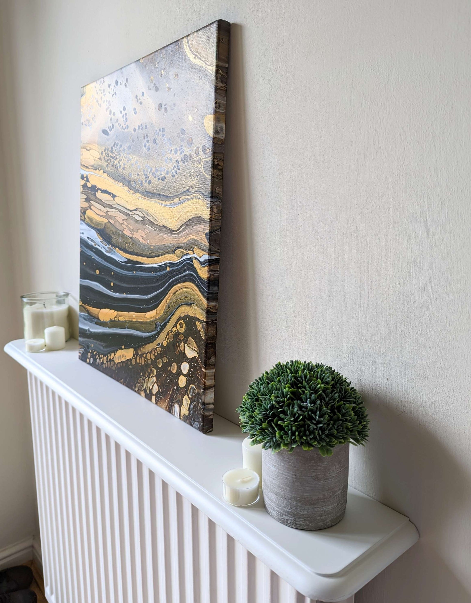 Canvas on shelf – side view of original abstract painting with high contrast and gold. Made with professional grade acrylic paint.