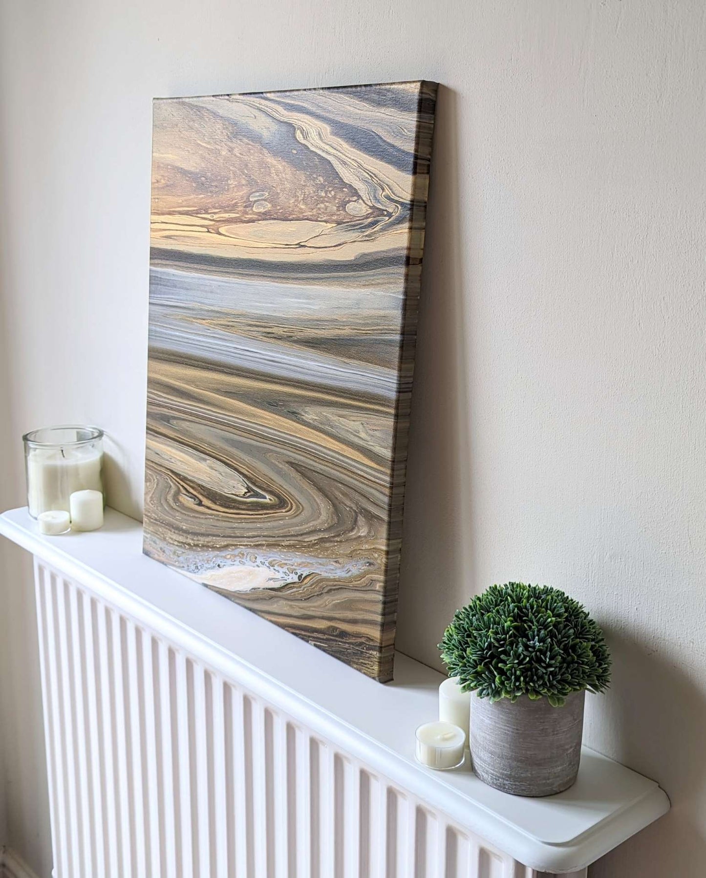 Canvas on shelf – side view of original abstract painting made in grey hues with gold made with professional grade acrylic paint.