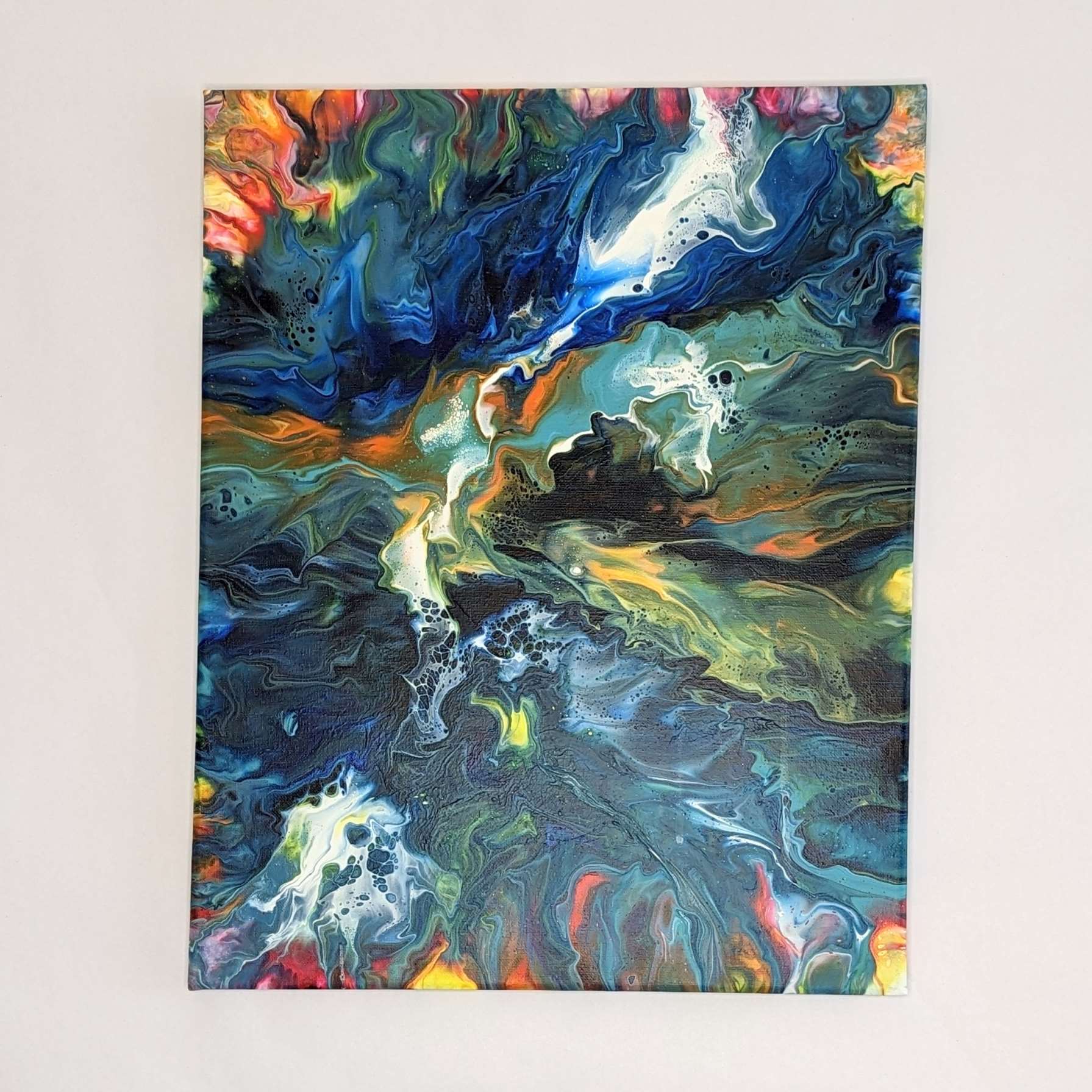 Canvas on wall – frontal view of original abstract painting in vibrant colours made with professional grade acrylic paint.