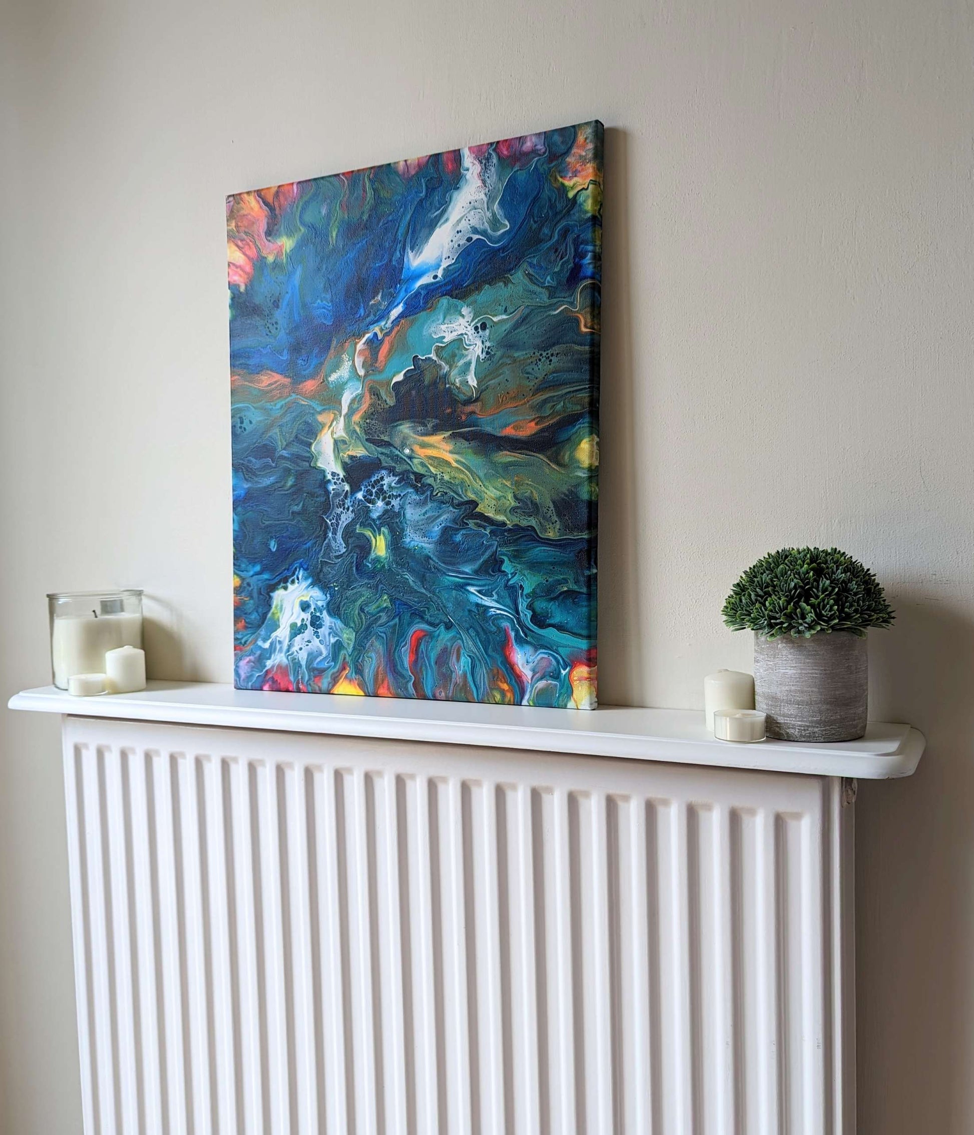 Canvas on shelf – frontal view of original abstract painting in vibrant colours made with professional grade acrylic paint.