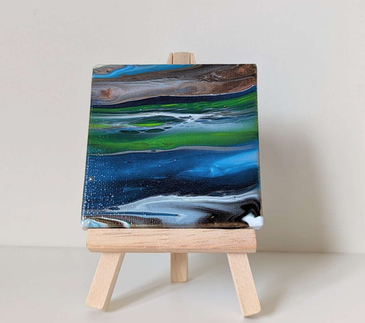 Frontal view of ultra mini original abstract painting on easel.