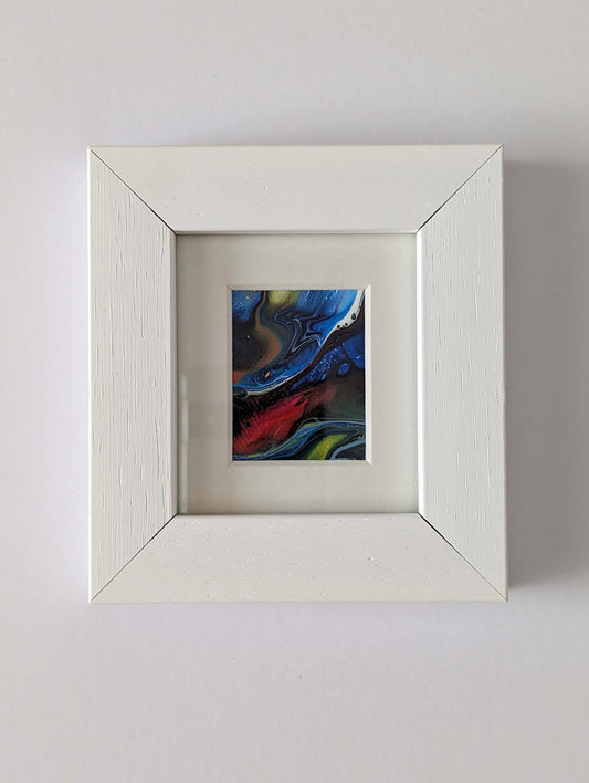 Frontal view of framed ultra mini original abstract painting in primary colours. 