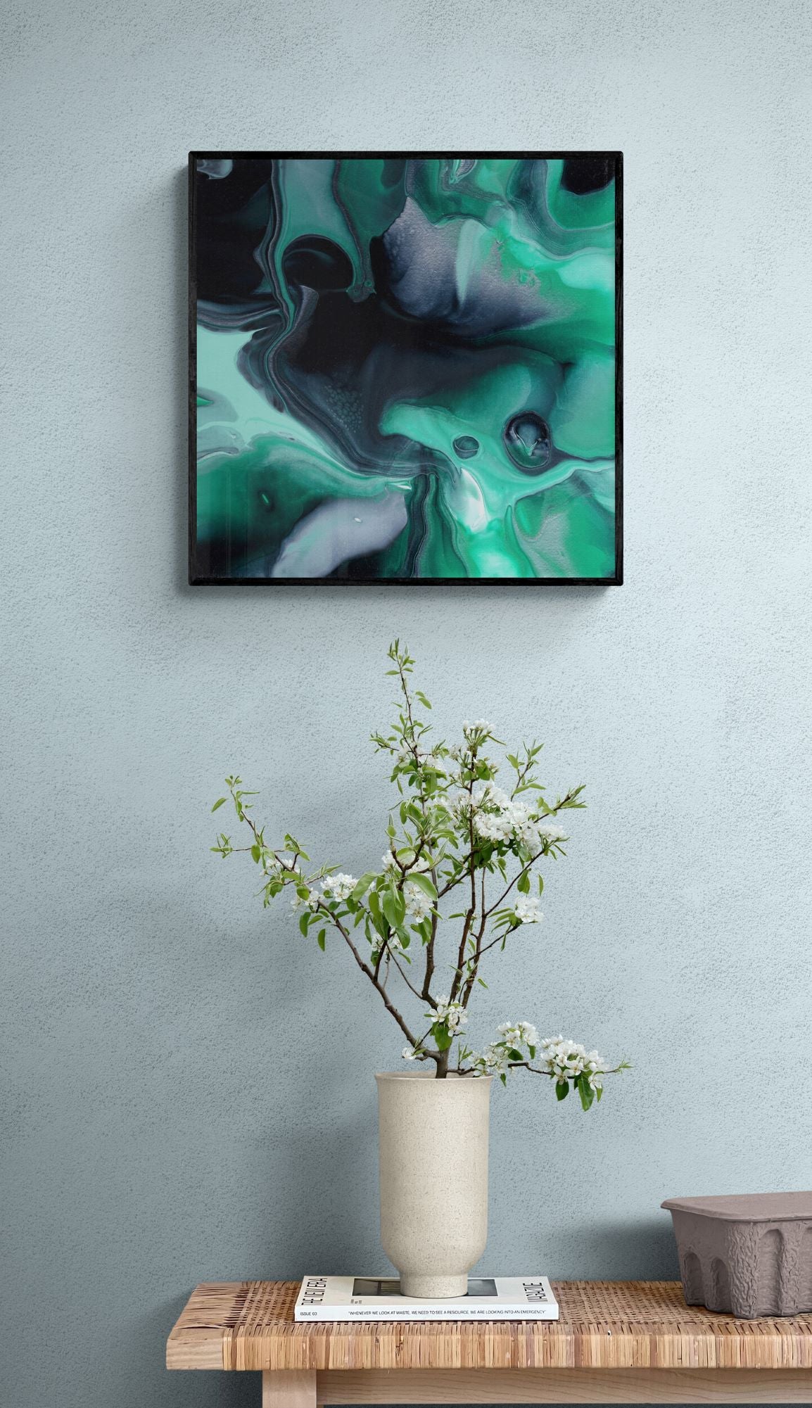 a 50x50 cm print over a side table with a plant on it