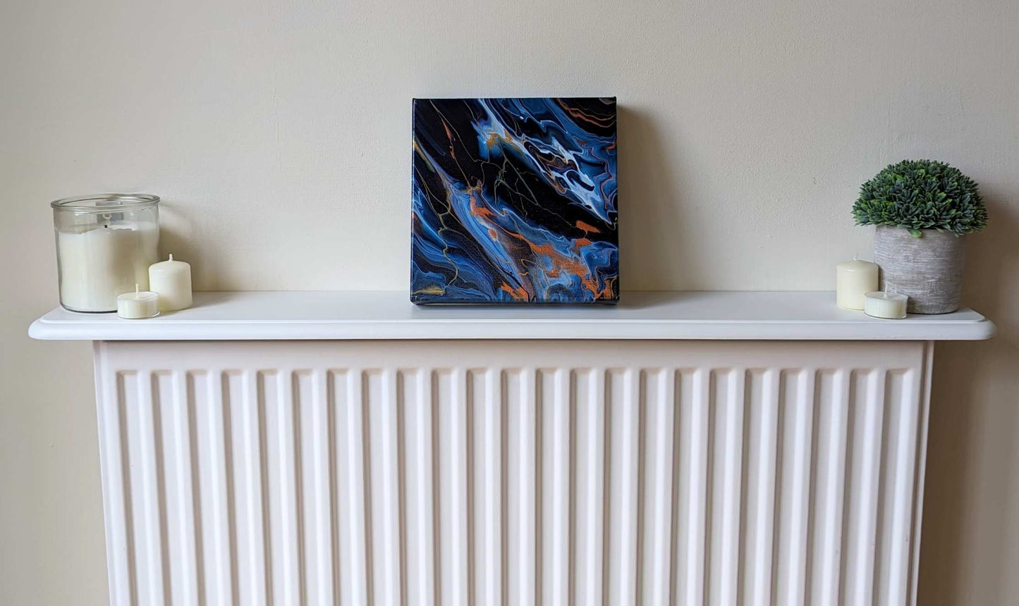 Canvas on shelf – frontal view of original abstract painting made with Prussian blue, copper, and gold professional grade acrylic paint.