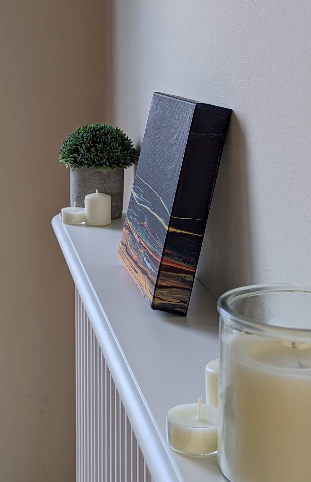 Canvas on shelf – side view of original abstract painting made with Prussian blue and gold professional grade acrylic paint.